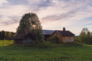 Wall Mural - Sunset by the abandoned farm in spring.