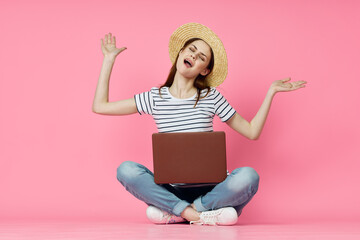 woman with laptop on pink background online shopping entertainment