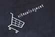 Chalk drawing of shopping cart and word acknowledgment on black chalboard. Concept of globalization and mass consuming