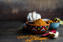 Bowl Of Adjika Spice With Dried Chilli, Chilli Peppers, Salt, Garlic And Bay Leaves On A  Table