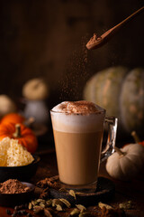 Poster - Vertical shot of coffee latte with cinnamon on top