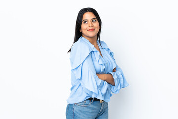 Wall Mural - Young latin woman woman isolated on white background looking to the side and smiling