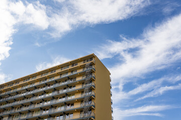 Wall Mural - Low angle photo of a simple styled beige residential building on a clear day