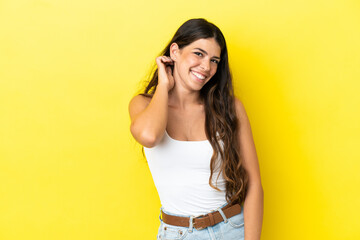 Young caucasian woman isolated on yellow background laughing