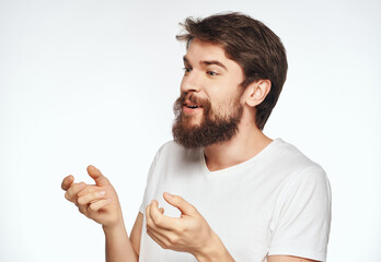 Canvas Print - Cheerful man with a beard in a white T-shirt gestures with his hands