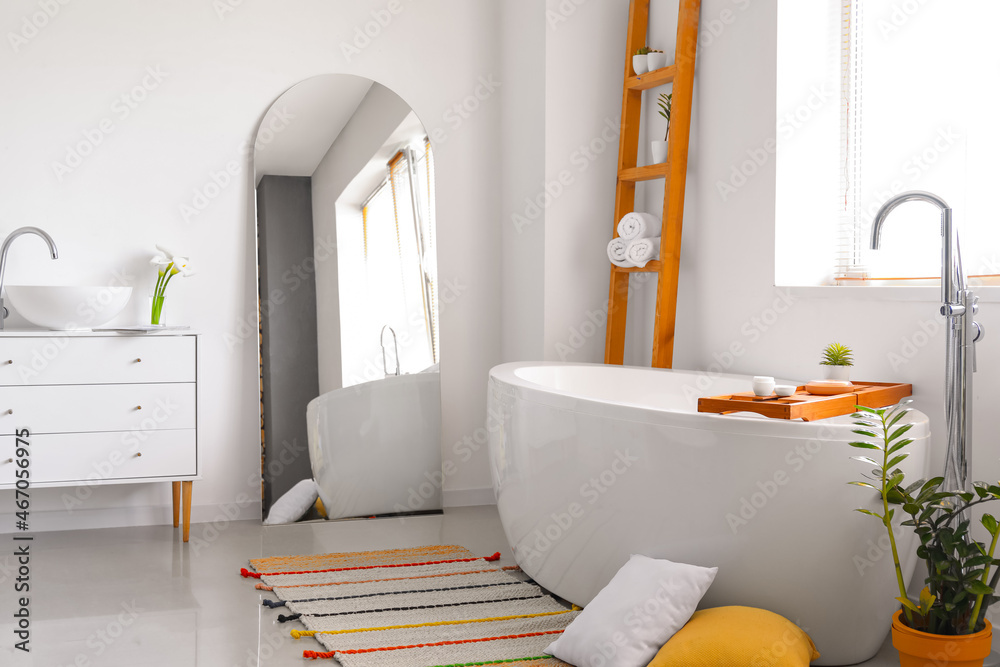 Interior of light bathroom with mirror