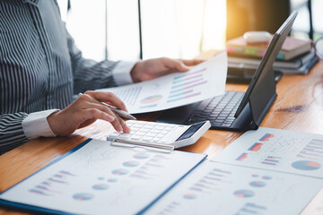 business woman using calculator to do math finance statistics and tax.