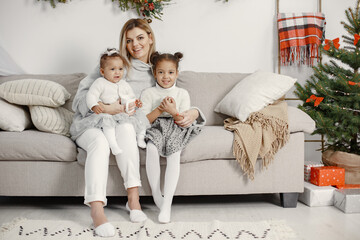 Caucasian mother with two little african daughters at home