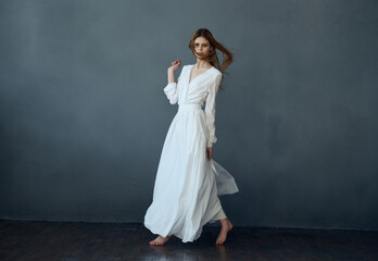 Canvas Print - Woman in white dress dance posing isolated background