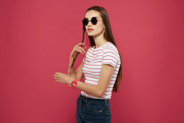 Wall Mural - pretty woman in striped t-shirt sunglasses pink background glamor