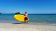 © Aboltin - Active male surfer running with surfboard on sand beach enjoying healthy lifestyle extreme sport
