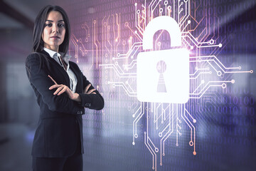 Aufkleber - Attractive young european businesswoman with folded arms standing in blurry office interior with glowing circuit padlock hologram. Digital safety and security concept. Double exposure.