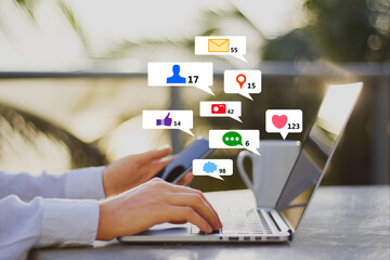 Aufkleber - Close up of businessman hands at desk using laptop and smartphone with creative social media icons on abstract blurry outdoor background. Like, network, technology and communication concept.