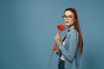 Wall Mural - pretty woman wearing glasses red flower summer style blue background