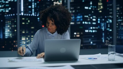Poster - Successful African American Businesswoman Working on Laptop Computer in Big City Office Late in the Evening. Female Executive Director Managing Digital e-Commerce Project, Finance Analysis.
