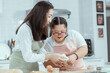 © 2B - Young Downs Syndrome Couple Baking In Kitchen At Home