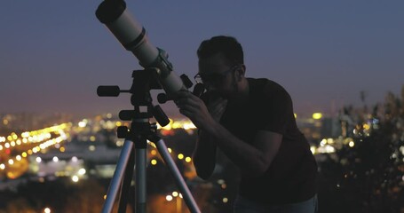 Wall Mural - silhouette of a man, telescope and city lights under the starry skies.