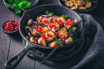 Wall Mural - Baked small eggplants, stuffed with mushrooms and pomegranate