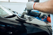 © Drazen - Close-up of worker polishes car hood while working at service workshop.