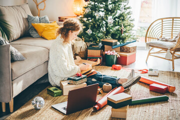 Woman making to do list on 2022 year at notebook.