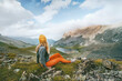 Hiker woman looking at lake and mountains view travel hiking alone outdoor active vacations adventure lifestyle solo trip