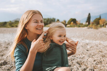 Mother And Daughter Playing Outdoor Family Lifestyle Happy Smiling Emotions Blonde Hair Woman And Child Girl Travel Vacations Holidays