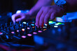 © Scopio - DJ playing music using audio mixer