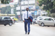 © Scopio - Man in blue suit holding his blazer walking down the street