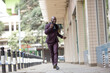 © Scopio - Man in purple happily walking on sidewalk