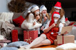 © ako-photography - group of women wearing Christmas hats and protective face masks, take video calls during coronavirus