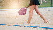 Woman playing beach tennis on a beach. Professional sport concept