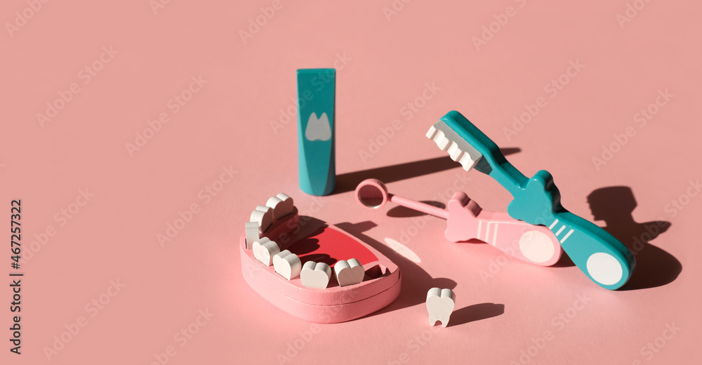 Wooden model of a jaw with a lost molar tooth and tools for daily ...
