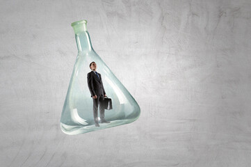 Wall Mural - Business man standing inside a glass bottle