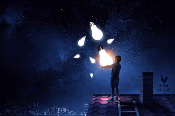 Wall Mural - Boy with a glowing light bulb