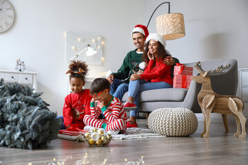 Happy family with children celebrating Christmas at home