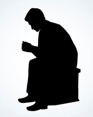 Wall Mural - The guy is sitting on a stool. Vector drawing