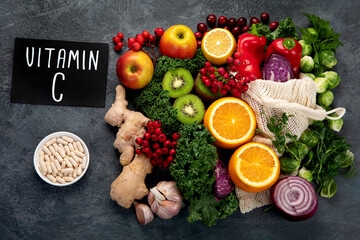 Wall Mural - Foods high in vitamin C on dark background.