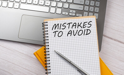 Poster - MISTAKES TO AVOID text written on a notebook on the laptop
