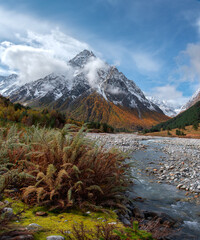 Poster - The Tihtengen mountain range covered in clouds with a bush and river in front