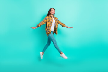 Sticker - Full size photo of mature joyful brunette lady run wear shirt jeans sneakers isolated on turquoise background