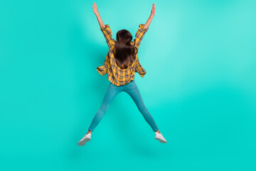 Sticker - Full body back photo of young cool brunette lady jump wear shirt jeans footwear isolated on turquoise background