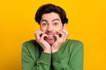 Poster - Photo of young crazy happy positive man bite teeth nails wait anticipation gift news isolated on yellow color background