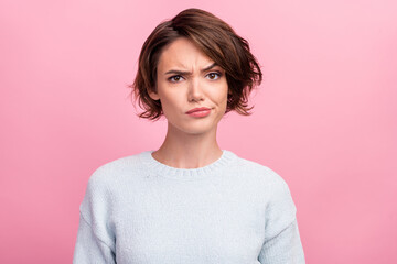 photo of unhappy young woman bad mood irritated problem raise eyebrow isolated on pink color backgro