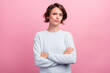 Photo of unhappy upset doubtful young woman hold hands crossed bad mood dislike isolated on pink color background