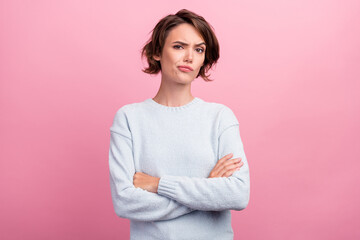 Canvas Print - Photo of unhappy upset doubtful young woman hold hands crossed bad mood dislike isolated on pink color background