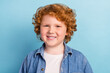 © deagreez - Photo of positive glad nice small ginger boy toothy beaming smile wear denim jacket isolated blue color background