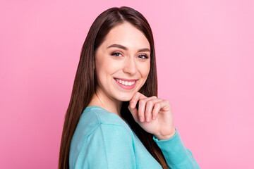 Sticker - Profile side view portrait of attractive long-haired cheerful girl touching chin isolated over pink pastel color background