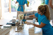 © ADDICTIVE STOCK - Young female housekeeper cleaning furniture during work in modern villa