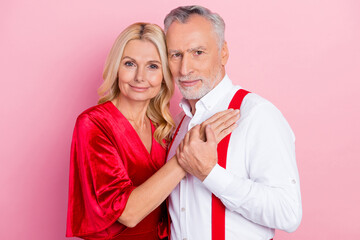 Poster - Portrait of two beautiful handsome tender gentle cheerful spouses hugging enjoying isolated over pink pastel color background