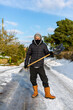 © Collins Photography - Portrait of a man preparing to clear a snow covered road with a snow shovel. Winter safety, clearing snow and ice concept